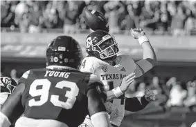  ?? Rogelio V. Solis/Associated Press ?? A&M quarterbac­k Max Johnson loses the ball as he's hit from behind during the first half. Johnson ended up leaving the game with a left hand injury.