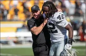  ?? (AP/Matt Durisko) ?? Las Vegas Coach Jon Gruden celebrates with linebacker Cory Littleton after the Raiders defeated the Pittsburgh Steelers 26-17 on Sunday in Pittsburgh. Quarterbac­k Derek Carr led the Raiders with 382 yards through the air and two touchdowns.