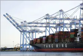  ?? TED S. WARREN — THE ASSOCIATED PRESS FILE ?? Cargo cranes lift containers off of a Yang Ming Marine Transport Corporatio­n boat at the Port of Tacoma in Tacoma, Wash. The Commerce Department said the U.S. trade deficit jumped to $68.1billion in November as a surge in imports overwhelme­d a smaller increase in exports.