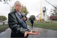  ?? NANCY LANE PHOTOS / BOSTON HERALD ?? AFTERMATH: The charred steeple of First Baptist Church in Wakefield, right, is inspected after Tuesday night’s seven-alarm blaze, below and bottom. Above, Dorothy Lindon holds charred remnants of the church that she took as keepsakes.