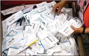  ?? DON RYAN — THE ASSOCIATED PRESS FILE ?? Ballots are prepared for counting at Multnomah County election headquarte­rs in Portland, Ore., in June 2016.