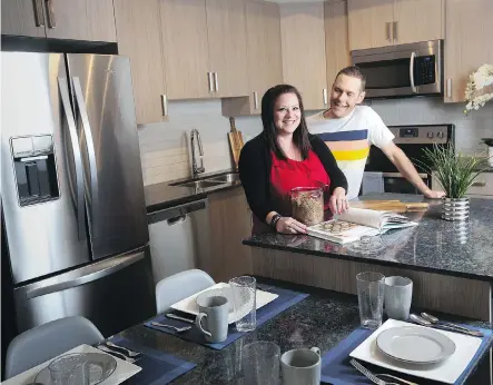  ?? CHRISTINA RYAN ?? Amanda and Adrian Goldsmith are excited about moving into their new Mark 101 condominiu­m in Sage Hill. Discoverin­g their love for travel led the couple to moving from a four-bedroom single-family home to a condominiu­m about half the size.