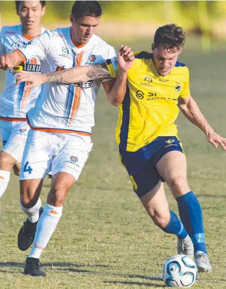  ?? Picture: AAP/STEVE HOLLAND ?? Gold Coast United's Brandon Reeves (right) does battle with Lions’ Matija Simic on Saturday.
