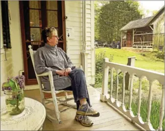  ?? PETER HVIZDAK — NEW HAVEN REGISTER ?? Beth Payne, Dudley Farm Museum Director, takes in a view of the Big Barn from the porch of the Dudley Farm Museum farmhouse in Guilford Friday, May 12, 2017. The Dudley Farm is raising funds for phase 3 of the Big Barn Project, which is an effort to...
