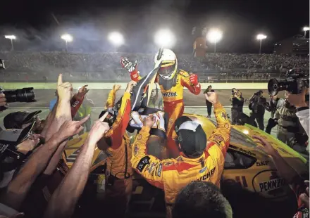  ?? GETTY IMAGES ?? Joey Logano celebrates after winning the NASCAR Cup Series Ford EcoBoost 400 and season championsh­ip on Sunday.
