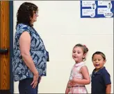  ?? SARAH GORDON/ THE DAY ?? From left, preschool teacher Natalie Rudyk lines up with students Madison Daniels and Nico Ennis during the first day of school on Wednesday at Preston Veterans’ Memorial School.