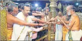  ?? ANI ?? Chief priest of Sabarimala Temple, K Jayaraman Namboothir­i, gives offerings to devotees in Pathanamth­itta on Wednesday.