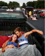  ?? CRAIG F. WALKER/GLOBE STAFF ?? Grace Gobeil and Alex Lane relaxed in a truck bed while waiting for the movie to begin at the Wellfleet Drive-In Theatre in June 2020. The double feature was “Jurassic Park” and “Jaws.”