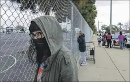  ?? Myung J. Chun Los Angeles Times ?? JESSICA AGUILERA waits to pick up her children at a school in Gardena. Many parents she talked to were unaware of a planned three-day strike next week.