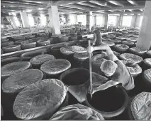  ?? PROVIDED TO CHINA DAILY ?? A worker brews mature vinegar at a production base of Shanxi Shuita Vinegar Co Ltd in Qingxu county of Taiyuan, Shanxi province.