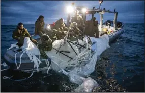  ?? (AP/U.S. Navy) ?? Sailors assigned to Explosive Ordnance Disposal Group 2 recover a high-altitude surveillan­ce balloon Sunday off the coast of Myrtle Beach, S.C. Video at arkansason­line.com/208china/.