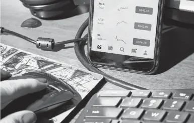  ?? AMY LOMBARD/THE NEW YORK TIMES ?? According to the Federal Reserve, American households bought roughly $211 billion in individual stocks last year — the highest level since 2014. But there’s no telling how long they will keep their pandemic-bred focus on the market.