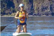  ??  ?? Challenge accepted: stand-up paddle boarding is not for the faint of heart, but it’s certainly worth a try.