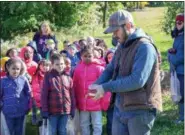  ?? EMILY OVERDORF — FOR DIGITAL FIRST MEDIA ?? Rupert Elementary kindergart­ners learn how to skin an apple from an expert during an Oct. 25 field trip to Frecon Farms in Berks County. More photos on page A1.