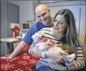  ?? Nikki Sullivan / Cape Breton Post ?? First time parents, Andrew and Amanda Burke, lovingly talk to their daughter, Alexia Jacqueline. Weighing eight pounds six ounces, Alexia was the first baby born in Nova Scotia in 2018, arriving at 12:06 a.m. on Sunday.