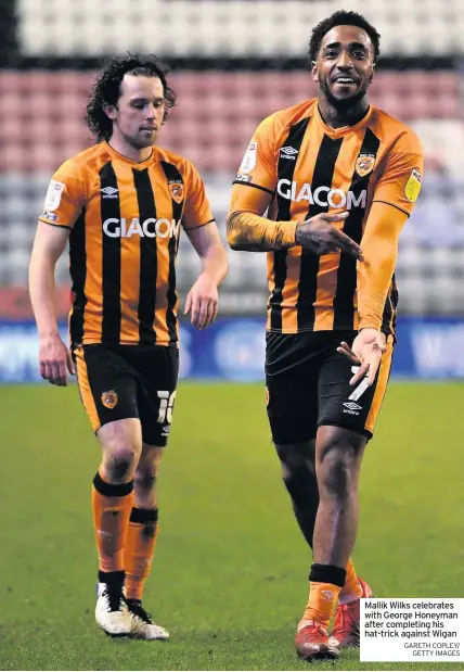  ?? GARETH COPLEY/ GETTY IMAGES ?? Mallik Wilks celebrates with George Honeyman after completing his hat-trick against Wigan