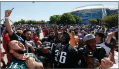  ??  ?? Philadelph­ia Eagles AP/MICHAEL AINSWORTH fans celebrate at the NFL Experience before the start of the draft Thursday at AT&T Stadium in Arlington, Texas.