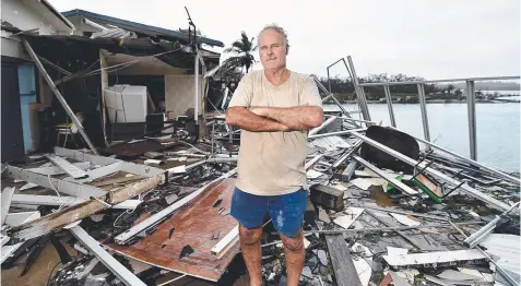  ?? Picture: ALIX SWEENEY ?? REBUILD: Airlie Schute Harbour Motel owner Dave McInnerney stands among wreckage caused by Cyclone Debbie.