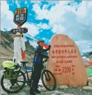  ?? CHINA DAILY PROVIDED TO ?? Fu Qisheng poses with the altitude marker at the base camp of Mount Qomolangma in the Tibet autonomous region.
