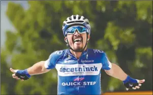  ?? The Associated Press ?? THIRD STAGE WINNER: France’s Julian Alaphilipp­e celebrates as he crosses the finish line Monday to win the third stage of the Tour de France cycling race over 215 kilometers (133,6 miles) with start in Binche and finish in Epernay.