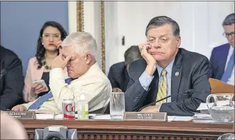  ?? [J. SCOTT APPLEWHITE/THE ASSOCIATED PRESS] ?? After eight hours of debate Wednesday, House Rules Committee Chairman Pete Sessions, R-Texas, left, and Vice Chairman Tom Cole, R-Okla., appear fatigued as they listen to arguments on the final version of the Republican health-care bill before it goes to the floor for debate.