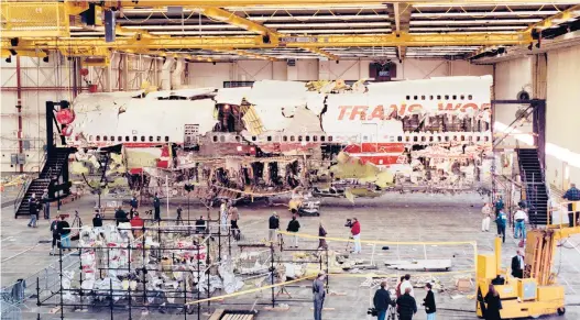  ?? VIC DELUCIA/THE NEW YORK TIMES ?? Wreckage recovered from TWA Flight 800 is assembled inside a hangar July 11, 1997, in Calverton, New York. The National Transporta­tion Safety Board has announced plans to decommissi­on and destroy the remaining wreckage.