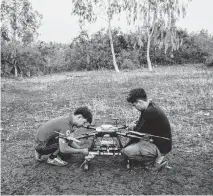  ?? ADAM FERGUSON NYT ?? Shan Gyi and another member of a Karenni Nationalit­ies Defense Force drone team test a drone Feb. 1 in Karenni State, Myanmar.