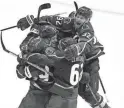  ?? JACK DEMPSEY/AP ?? Avalanche defenseman Josh Manson is congratula­ted by teammates after an overtime goal against the Blues on Tuesday.