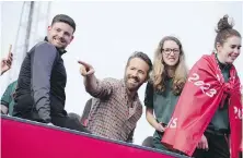  ?? JON SUPER, THE ASSOCIATED PRESS ?? Wrexham FC co-owner Ryan Reynolds, centre, celebrates with members of the Wrexham team the promotion to the Football League in Wrexham, Wales, in May 2023.