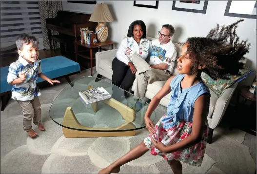  ?? Chicago Tribune/TNS/NUCCIO DINUZZO ?? Rachel and Erik Gregersen sit with their children Wesley, 3, and Eva, 8, in their home in Elmhurst, Ill. The Gregersens have been married 11 years and have concerns about how their children will be treated outside of their home.