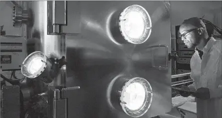  ?? JEFFREY CHILDS Brian van der Brug Los Angeles Times ?? observes an experiment inside a space radiation effects chamber on Aerospace’s El Segundo campus in 2010.