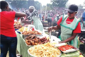  ?? Picture: Memory Mangombe ?? Members of the public buy food at the Police Commission­er-General’s Fun Fair at Morris Depot Harare yesterday. —