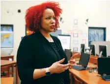  ?? STAFF PHOTO BY C.B. SCHMELTER ?? Nikole Hannah-Jones speaks with a local television station during a media availabili­ty before speaking at a UnifiEd event at Orchard Knob Elementary School on Thursday.