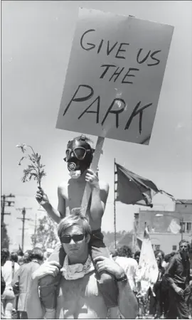  ?? HOWARD ERKER — OAKLAND TRIBUNE ?? Protesters gather and hold signs during a demonstrat­ion against the government's use of force in the conflict over People's Park in 1969. People's Park landed on the National Register of Historic Places last week. Dorm buildings are planned there later this year.