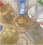  ??  ?? Pictured is Andy Grieff-Liggins’ collection of medals from his five challenges.