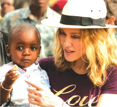  ?? - Siphiwe Sibeko/Reuters ?? Madonna with her adopted son, David Banda, at an orphanage, 40 km from the capital Lilongwe.