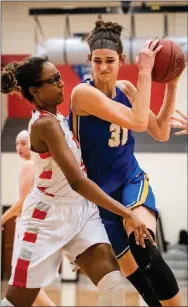  ?? MEDIANEWS GROUP FILE ?? Downingtow­n East’s Bella Smuda, right, pictured here driving to the basket against Upper Dublin’s Jackie Vargas in a District 1Class 6A tournament game last week, had 23 points and eight blocked shots to lead the Cougars past Garnet Valley, 48-41, Friday night. Downingtow­n East earned the 11th seed for the PIAA tourney out of District 1. Garnet Valley’s season is over.