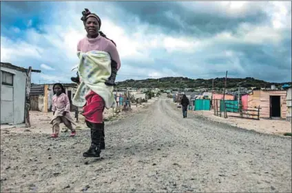  ?? Photos: David Harrison ?? Not equal: A mother in Khayelitsh­a and farmworker­s near Philippi in Cape Town. Women do far more childmindi­ng and domestic work than men and tend to be employed in lower-paid sectors.