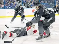  ?? O’MEARA / AP CHRIS ?? Lightning defenseman Ryan McDonagh carries the puck as Devils defenseman Ryan Graves tries to make a diving stop Saturday.