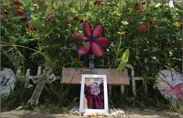  ?? (Arkansas Democrat-Gazette/Staton Breidentha­l) ?? A photo of Karma Wezowicz sits in front of a butterfly garden that Karma and her grandmothe­r, Brenda Wezowicz, had planned together before the 7-year-old was accidental­ly shot in late February 2017. She died a few days later; the garden grows in her memory.