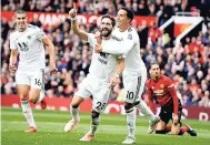  ?? AP PHOTOS ?? Wolverhamp­ton Wanderers’ Joao Moutinho (centre left) celebrates after scoring during the English Premier League match between Manchester United and Wolverhamp­ton Wanderers at Old Trafford stadium in Manchester yesterday.