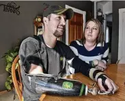  ?? Kimm Anderson / St. Cloud Times ?? Jamie Houdek and his wife, Lisa, talk about his losing a hand to a corn picker on their Minnesota farm. Even seasoned farmers can make mistakes in a moment of haste, he says.