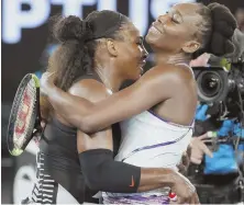 ?? AP PHOTO ?? SIBLING REVELRY: Serena Williams, left, is embraced by her sister Venus after beating her in the Australian Open for her record 23rd career Grand Slam title.
