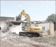  ?? File photos ?? Prairie Grove School District in 2023 demolished the 1954 high school building on Mock Street to make room for a new two-story addition to the junior high campus.