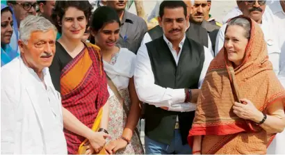  ?? AP ?? Congress party president Sonia Gandhi, her daughter Priyanka Vadra, son-in-law Robert Vadra, granddaugh­ter Miraya Vadra and party leader Satish Sharma in Amethi, Uttar Pradesh. —