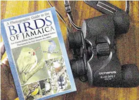  ??  ?? Tools of the bird-watching trade — a pair of binoculars and a detailed bird guide