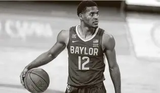  ?? Eric Gay / Associated Press ?? Guard Jared Butler is eager for Baylor’s return to the court against Iowa State on Tuesday night, equating the break due to the COVID-19 issues in the program to a child put into timeout.