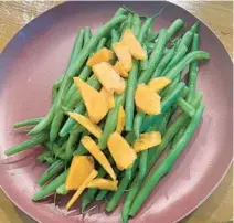  ?? DIANE ROSSEN WORTHINGTO­N/TNS ?? You can prepare in advance some components of this sumptuous green bean side dish that celebrates the season’s persimmons.