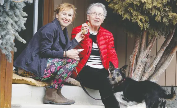  ?? BRENDAN MILLER ?? Suzanne Presinal, with her mother Alice Dombroski and three-legged dog Devi outside her southeast Calgary home, was a teacher at STEM Learning Lab but got laid off and has become proactive about how she spends money and uses things during the pandemic.