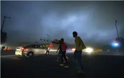  ?? — PTI ?? Vehicles ply on road with headlights on as dust storm hit Delhi on Saturday evening, plunging the city into darkness and throwing traffic out of gear.